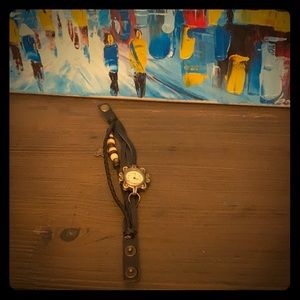 Black leather bracelet watch.